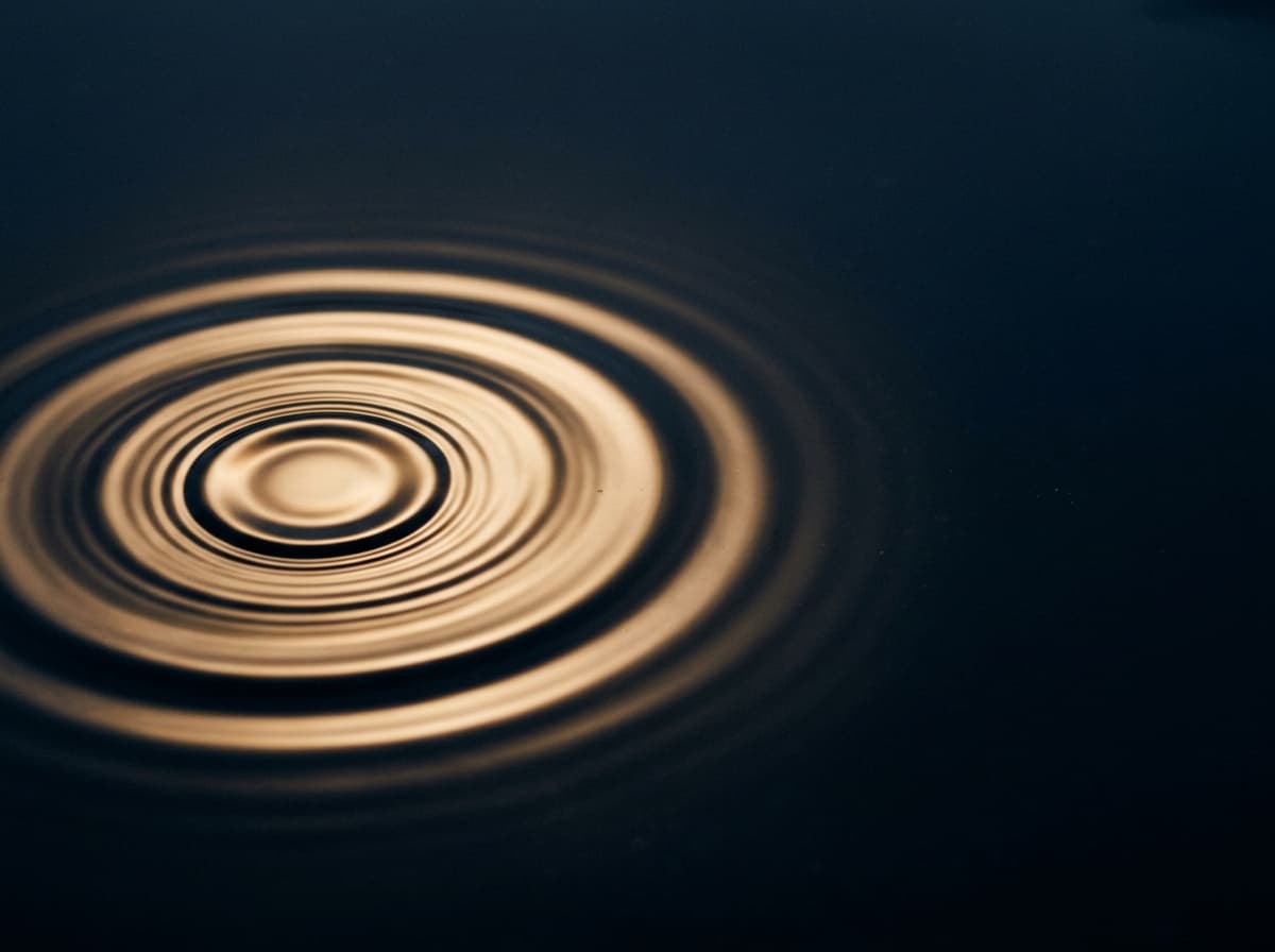 Concentric gold rings rippling toward a center point over deep navy.